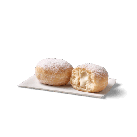 Kleine, gefüllte Bällchen mit Puderzucker auf einem weißen Teller