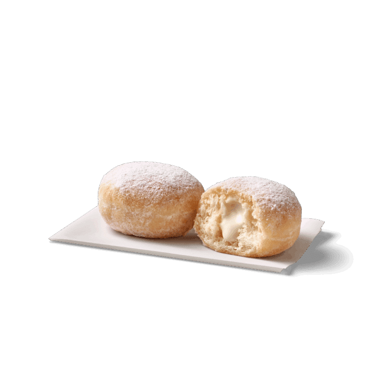Kleine, gefüllte Bällchen mit Puderzucker auf einem weißen Teller
